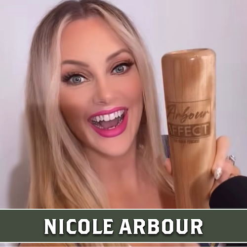 Nicole Arbour smiling and holding a wooden baseball bat mug engraved with The Arbour Effect logo.